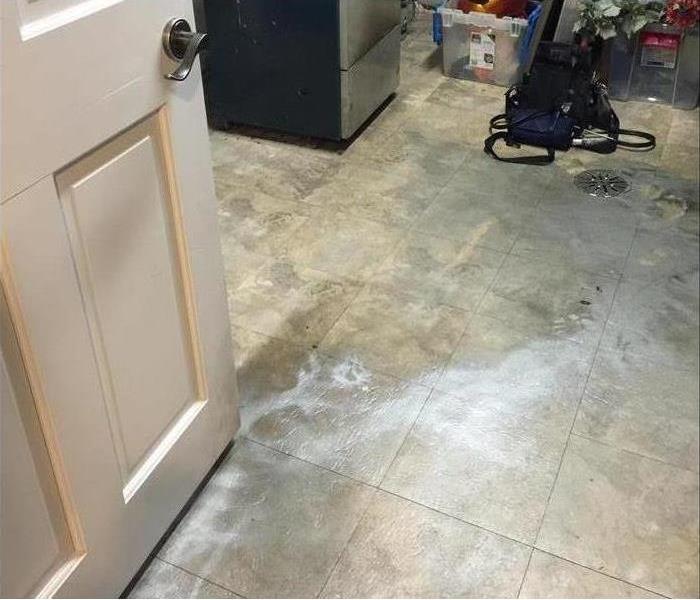 Black soot on a tile floor in a home